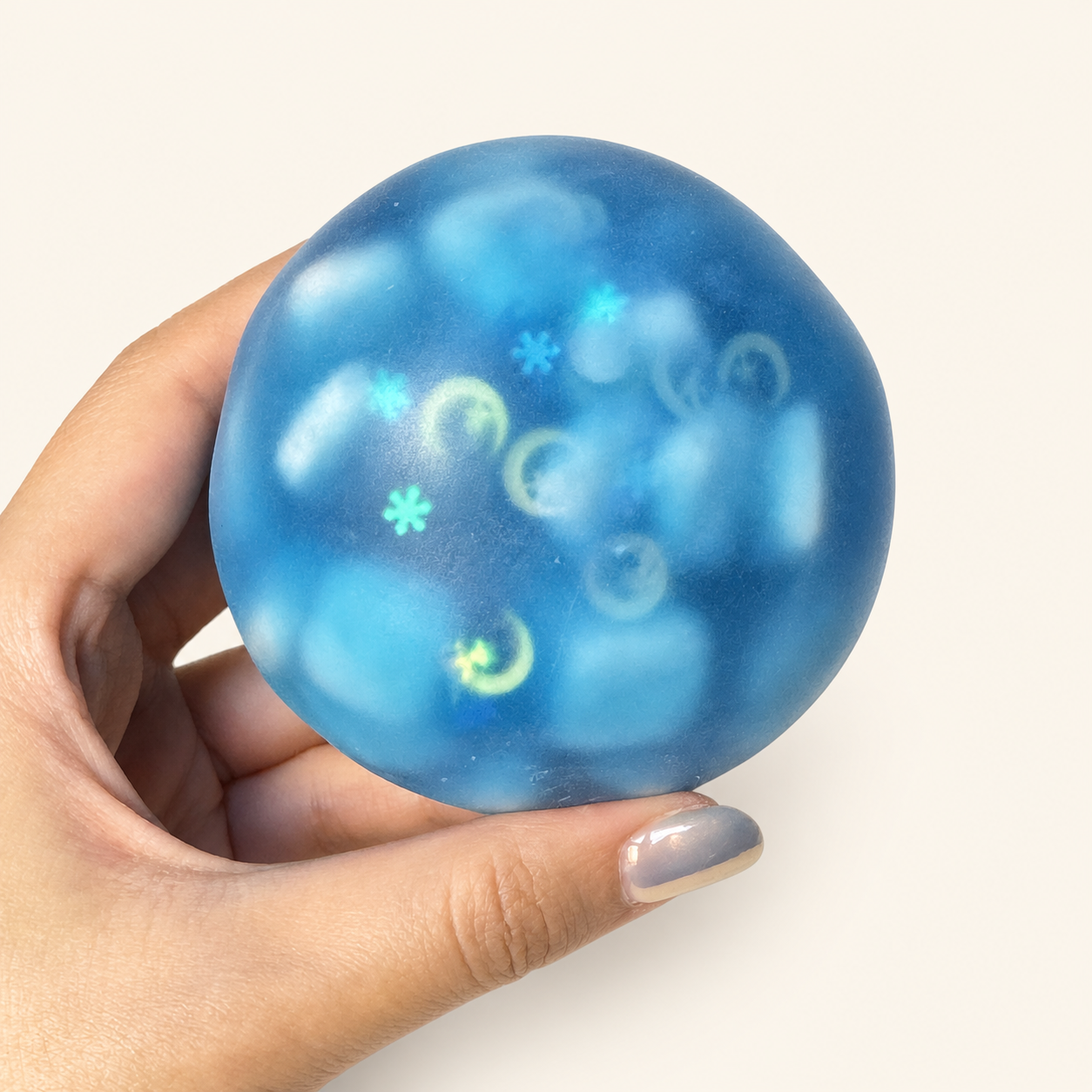 Hand holding the blue Moonlit Ocean Sensory Stress Ball
