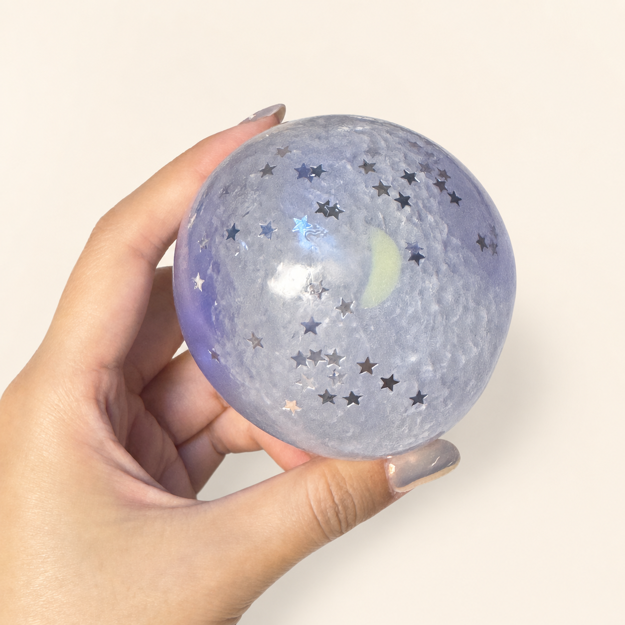 Crescent moon and silver stars inside the Purple Mist Stardust Slush Sensory Ball